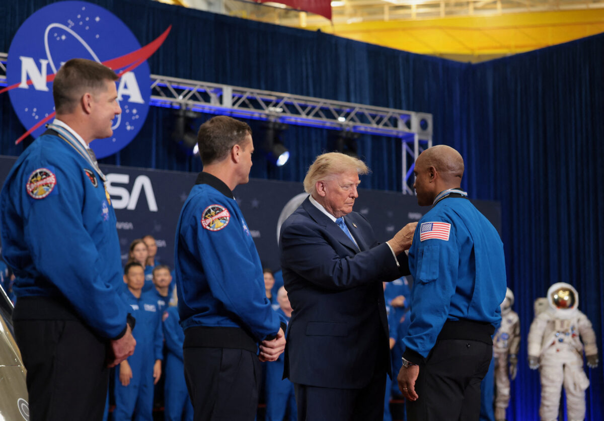 U.S. President Donald Trump presents NASA astronaut Victor Glover with a medal during a Congressional Space Medal of Honor presentation to the Artemis II crew at NASA's Johnson Space Center in Houston, Texas, U.S., August 28, 2026. REUTERS