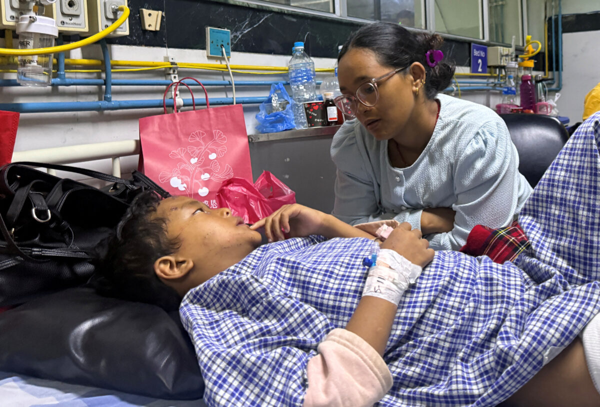 Matti Maya Tamang, 28, speaks with her son Zoyal Ghale, 8, who was airlifted from Rasuwa after being injured in the deadly flash floods and mudslide, two days after they were separated following the floods, inside a hospital in Kathmandu, Nepal, August 28, 2026. Picture taken with a mobile phone. REUTERS