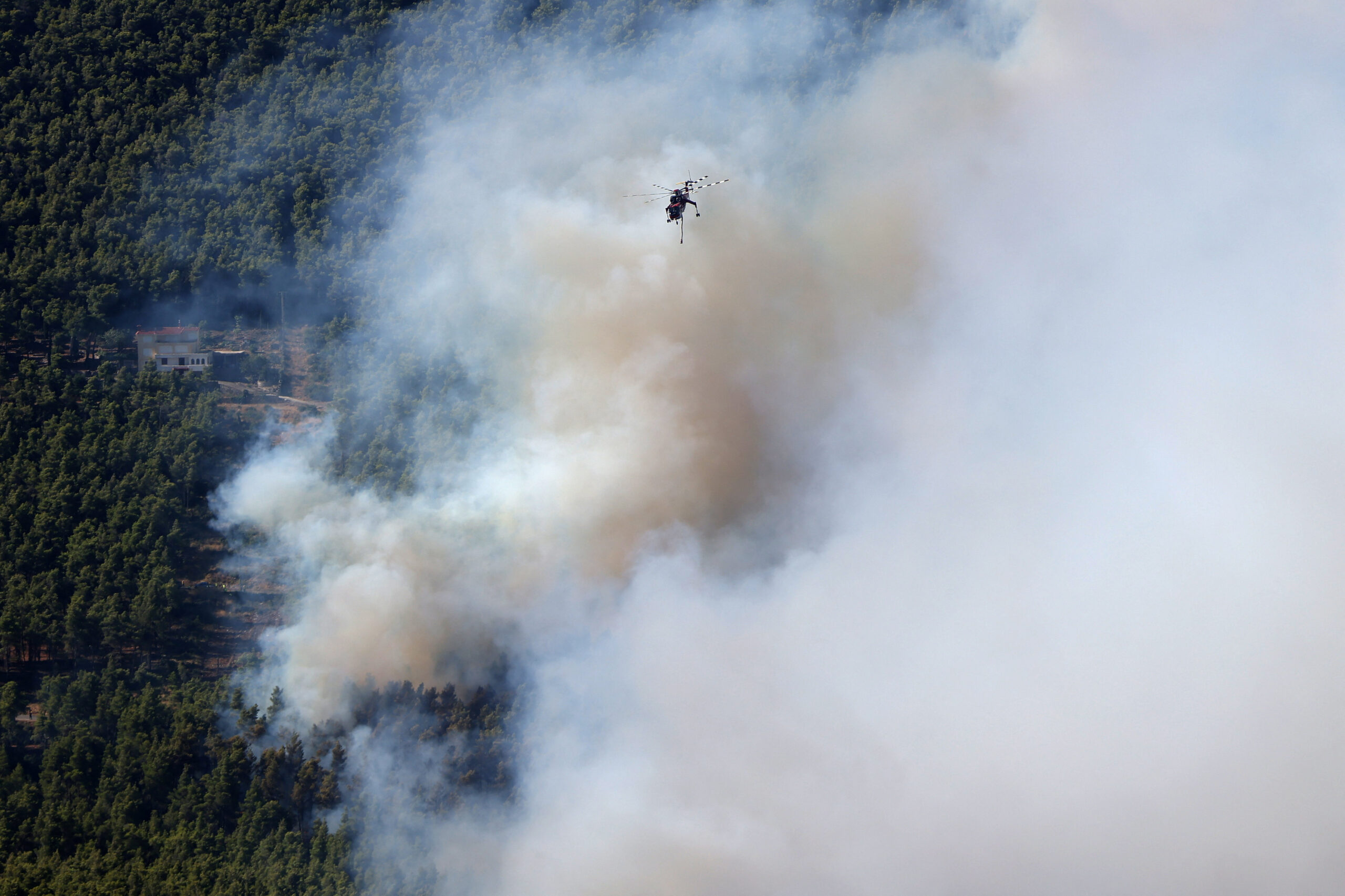Wildfire burns near Agia Paraskevi A firefighting helicopter flies over wildfire near the village Agia Paraskevi, Greece, August 2, 2026. REUTERS/Stelios Misinas