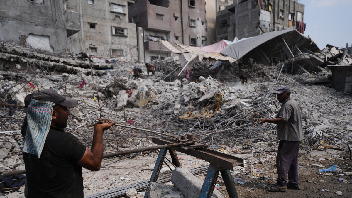 Palestinians remove iron from the rubble of buildings destroyed by Israeli airstrikes during the war with Hamas, repair and recycle it for construction, building tents or selling it, in Gaza City, Sunday, Aug. 16, 2026.