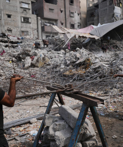 Palestinians remove iron from the rubble of buildings destroyed by Israeli airstrikes during the war with Hamas, repair and recycle it for construction, building tents or selling it, in Gaza City, Sunday, Aug. 16, 2026.