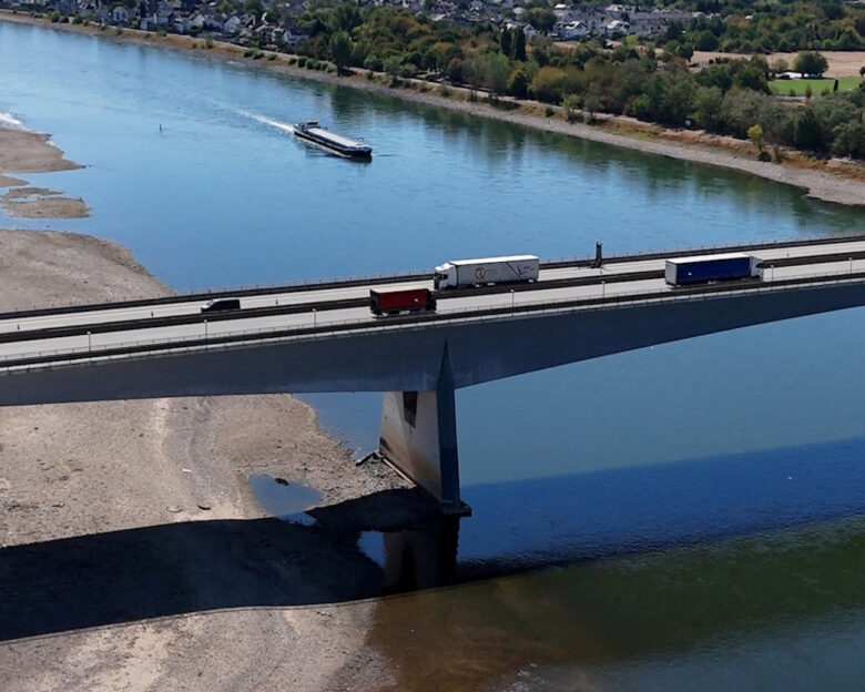 FILE PHOTO: Cars and trucks cross a bridge over the Rhine river on the Autobahn 48 highway near Bendorf, Germany, August 11, 2026, during prolonged dry weather across Europe that causes massive consequences for German industry.