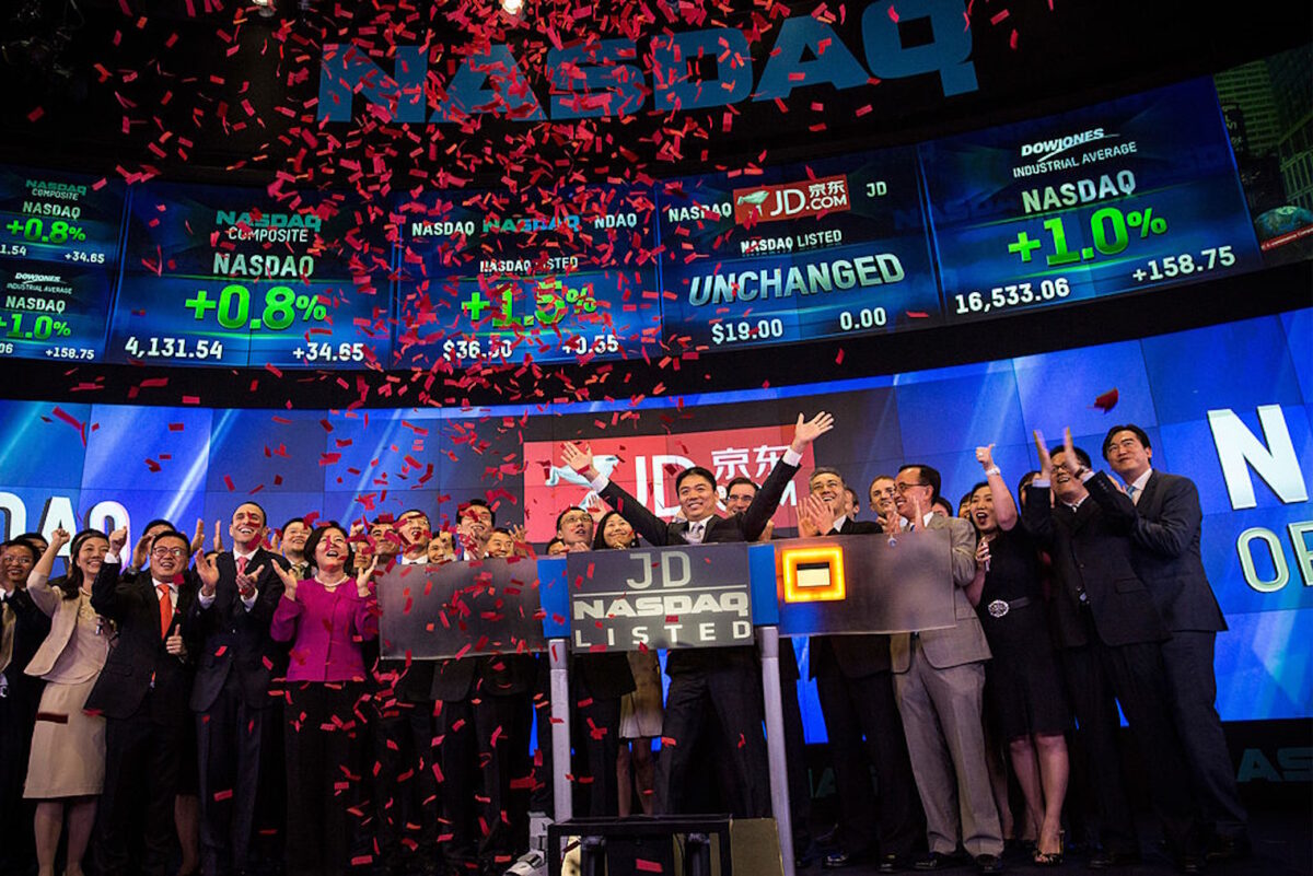 NEW YORK, NY - MAY 22: Richard Qiangdong Liu (C), founder, chairman and CEO of JD.com celebrates with employees as JD.com has its initial public offering (IPO) on the Nasdaq exchange on May 22, 2014 in New York City. JD.com is a popular online Chinese retail site.