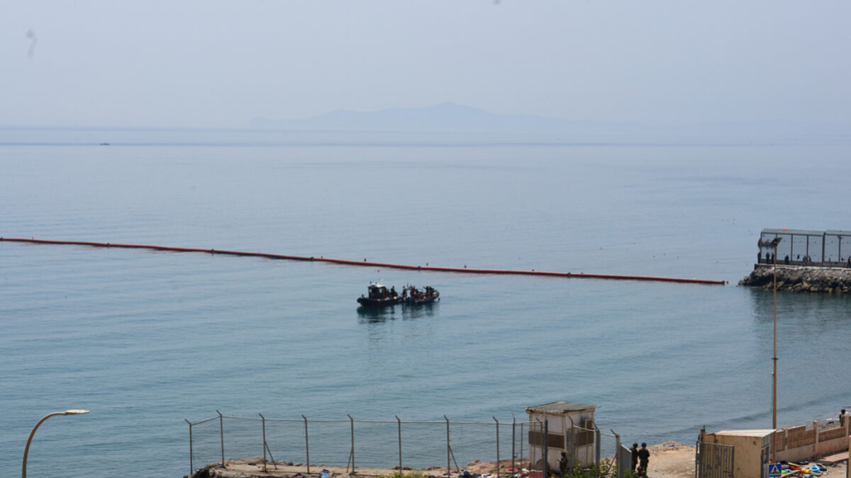 Civil Guard boats patrol alongside floating barriers off the coast of the Spanish enclave of Ceuta, Saturday, Aug. 1, 2026.
