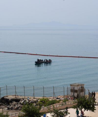 Civil Guard boats patrol alongside floating barriers off the coast of the Spanish enclave of Ceuta, Saturday, Aug. 1, 2026.