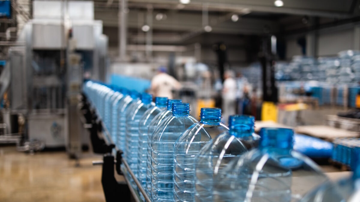 Industrial interiors or indoors and machinery. Factory line for bottling of pure spring water into bottles and canisters.