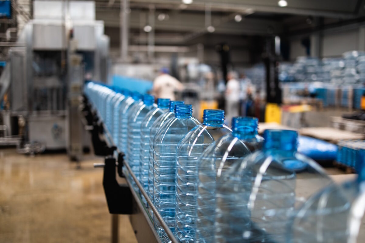 Industrial interiors or indoors and machinery. Factory line for bottling of pure spring water into bottles and canisters.
