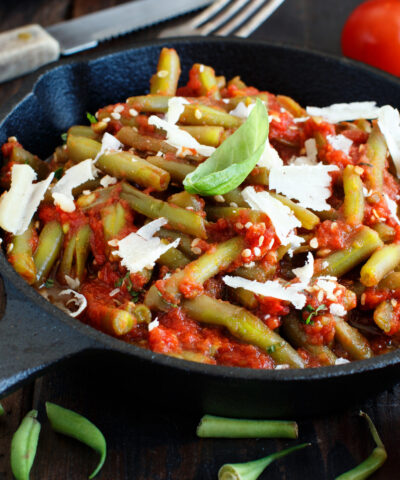 French beans with tomato stew top view on a dark table