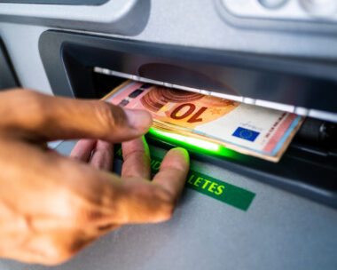 Close-up of the hand of a person withdrawing euro cash from an ATM machine