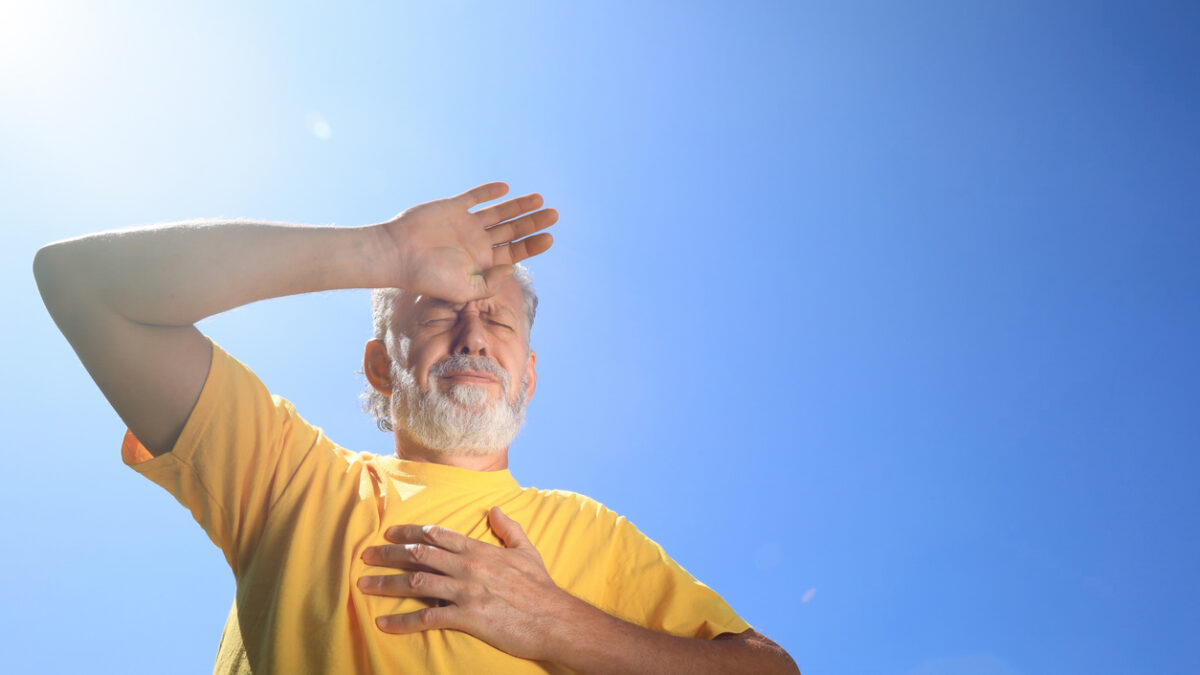 Senior man suffering from heat stroke outdoors