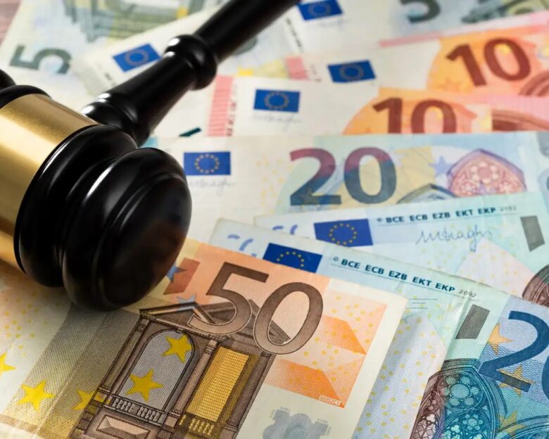 Gavel and stack European Union currency on the table.