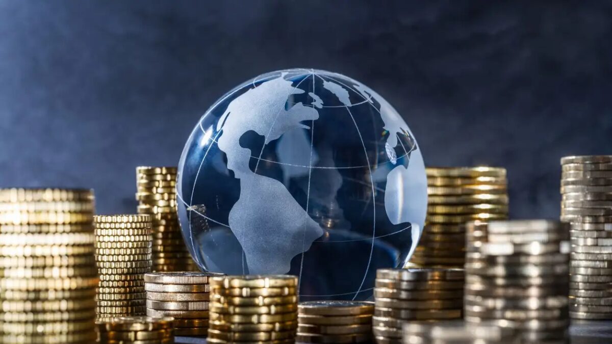 Globe and stack with coins. Money makes the world go round