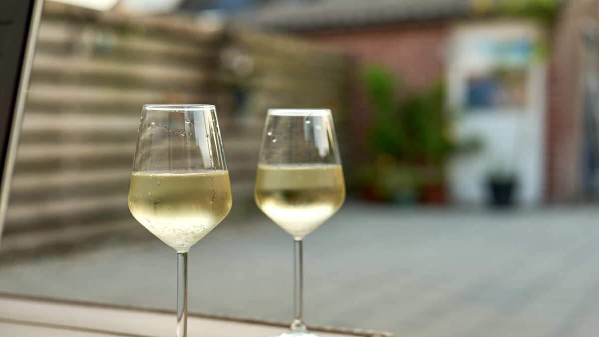 Refreshing white wine served in elegant glasses, creating a perfect moment of relaxation in a garden setting
