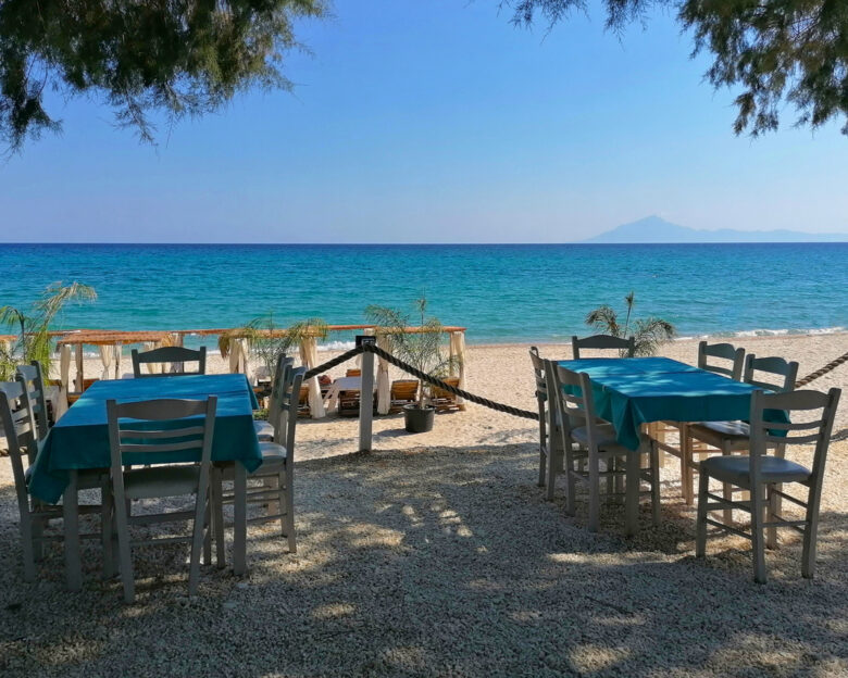 Tables and chairs on the beach of Thassos, Greece. Beautiful beach in Limenaria resort photo images