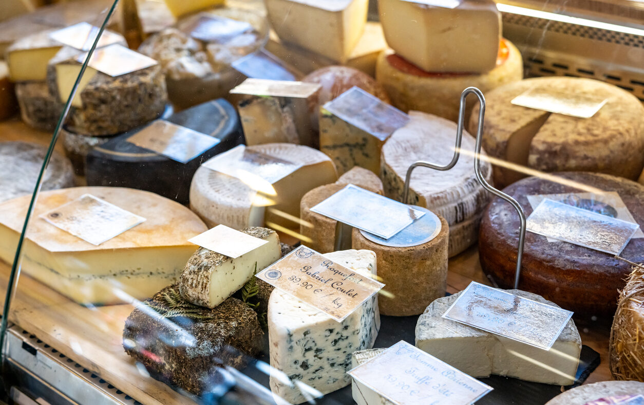 Assortment of French cheeses on display in Fromagerie display window in France