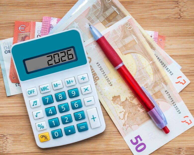 2026 numbers on a calculator and euros banknotes, new year finance, money and budget concept