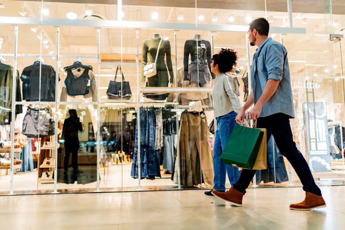 Couple walking through shopping mall