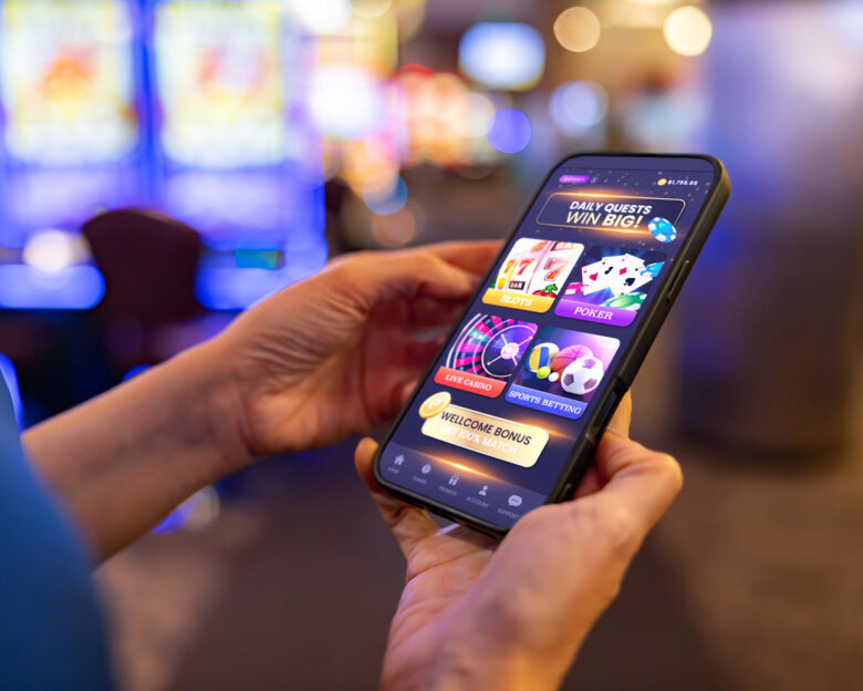 Close-up on a player gambling online at the casino using a mobile app on her cell phone