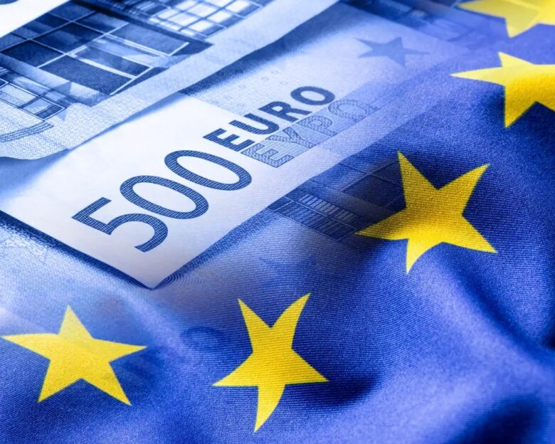 Euro flag. Euro money. Euro currency. Colorful waving european union flag on a euro money background.Euro flag. Euro money. Euro currency. Colorful waving european union flag on a euro money background