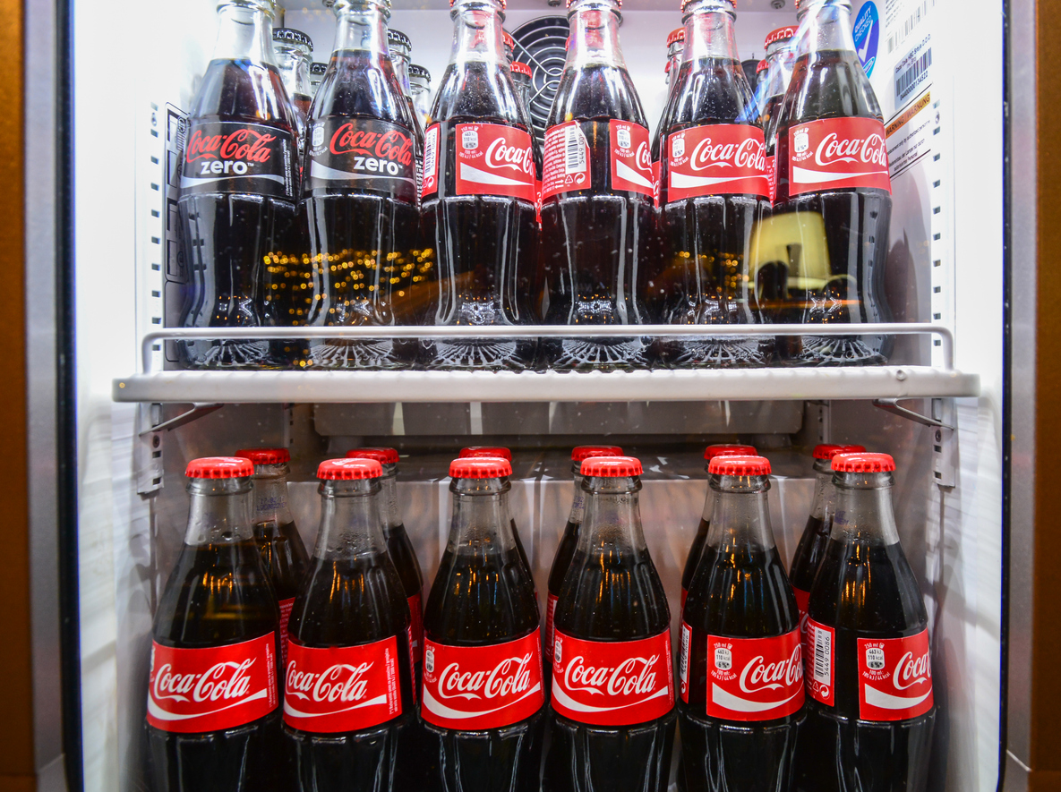 Glass bottles of famous coca-cola drink in the fridge. Picture was taken in Alloro, one of the restaurants in Subotica, Serbia. Photographed through fridge window.
