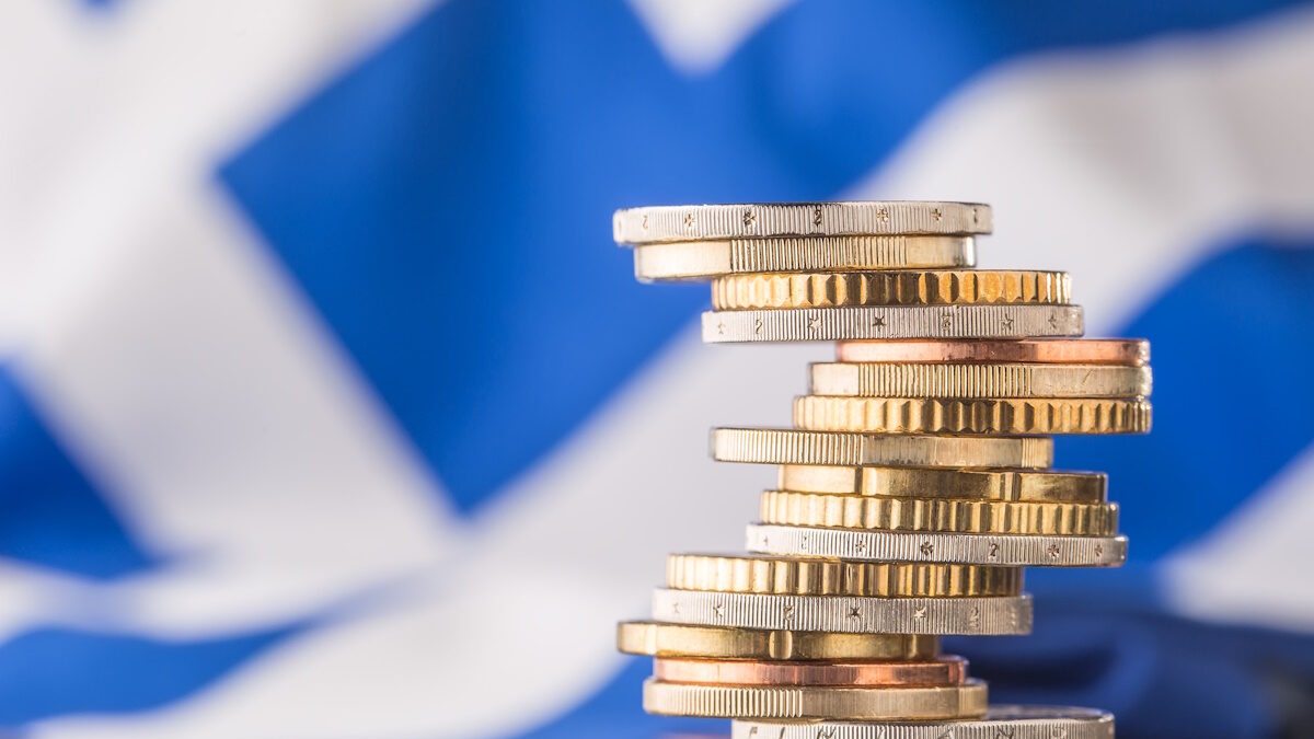National flag of greece and euro coins - concept. Euro coins. Euro money. Euro currency.