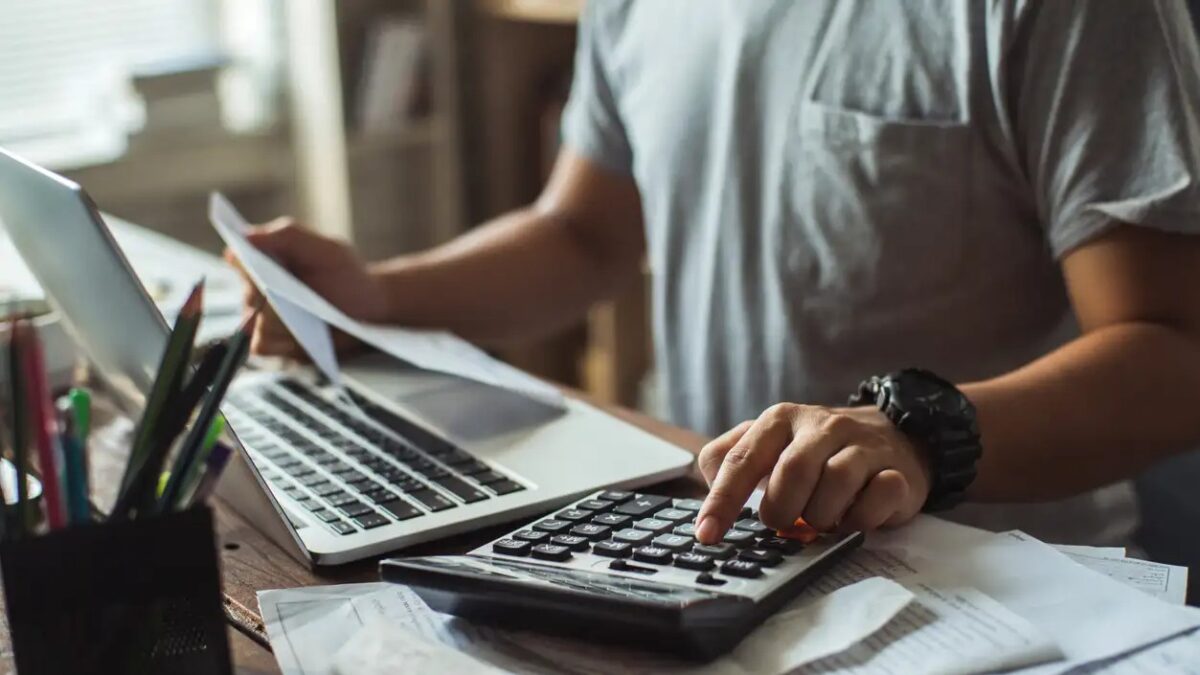 Men is calculating the cost of the bill. She is pressing the calculator.