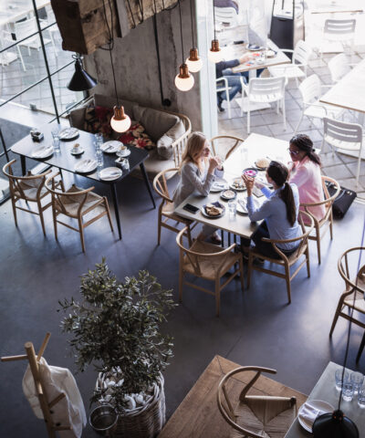 Three businesswomen having meeting and business lunch at high-end restaurant