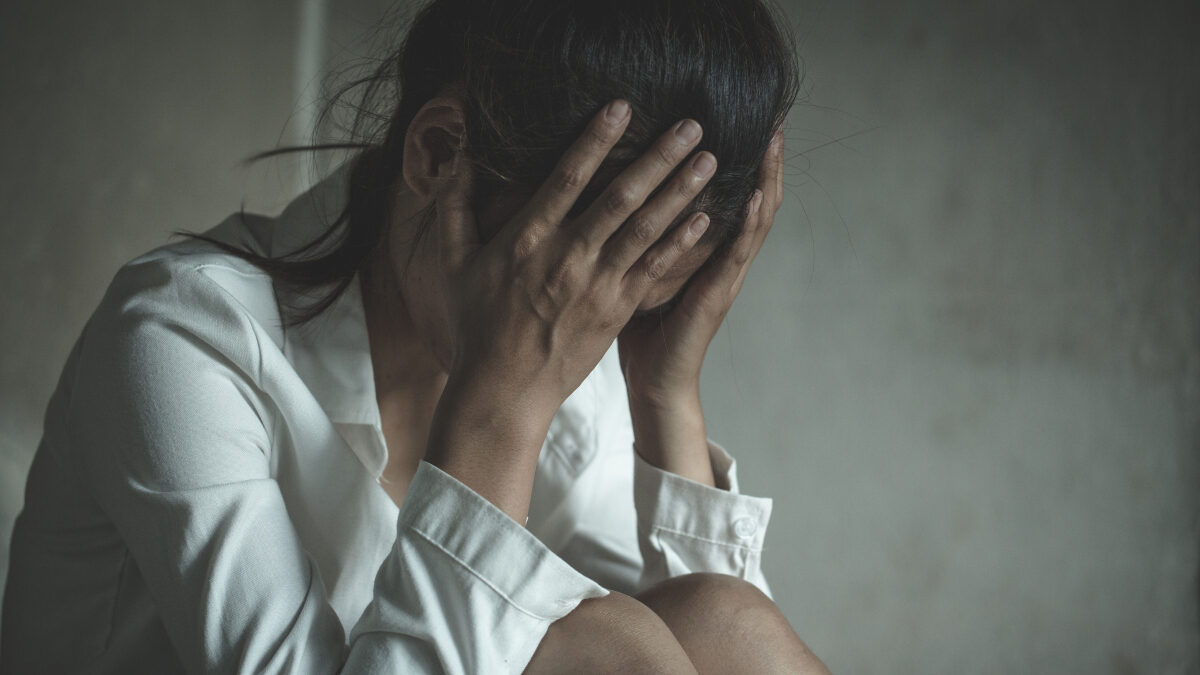 Young depressed woman, domestic and rape violence,beaten and raped sitting in the corner, Domestic violence.