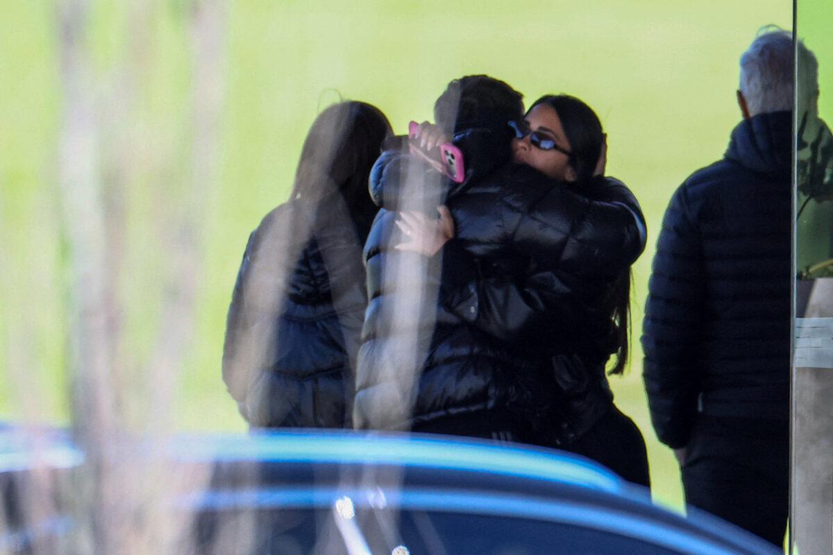 Antonela Roccuzzo, the wife of footballer Lionel Messi, hugs a person at El Prado Cemetery, following the death of Messi's father, Jorge Messi, in Perez, Rosario department, Argentina, August 9, 2026. REUTERS
