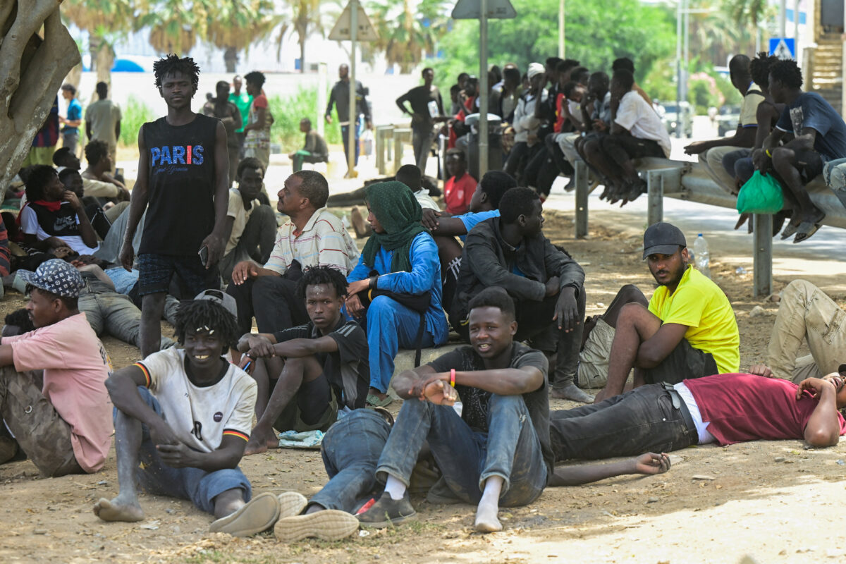 Migrants gather at Playa del Trampolin as they wait to enter a short-stay migrants centre CETI, following mass crossings of migrants on foot and by sea from Morocco into Spanish territory, in Ceuta, Spain, August 1, 2026. REUTERS