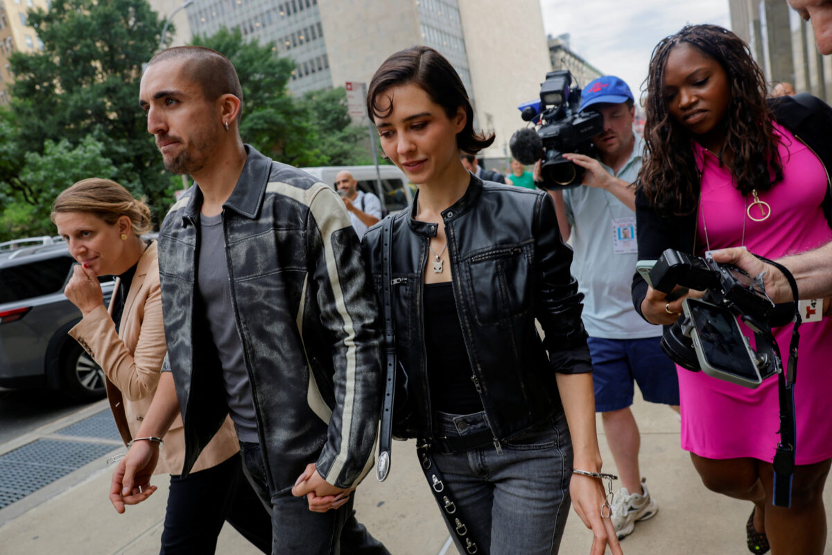 Angela Nikolau and Ivan Kuznetsov, who climbed the Empire State Building, leave court in New York City, U.S., August 24, 2026. REUTERS
