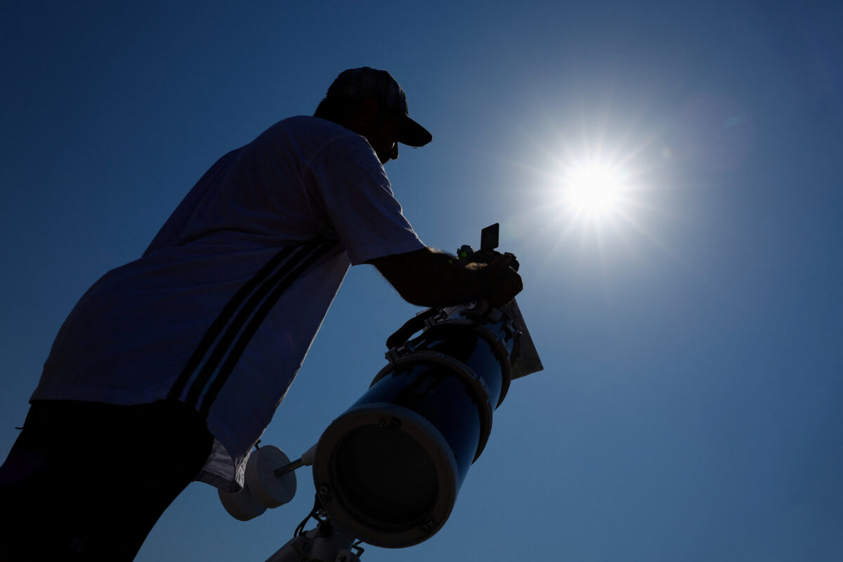 Frenchman Leyssalle Anthony, 39, prepares a telescope to view the total solar eclipse from the beach, in Arija, Spain, August 12, 2026. REUTERS/Borja Suarez