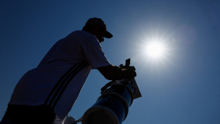 Frenchman Leyssalle Anthony, 39, prepares a telescope to view the total solar eclipse from the beach, in Arija, Spain, August 12, 2026. REUTERS/Borja Suarez