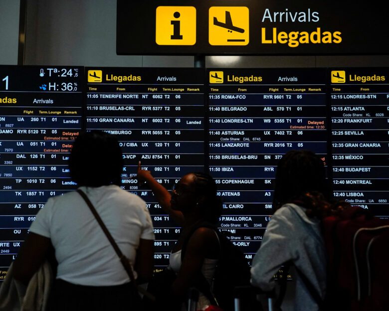 People look at an information panel displaying flight details at Adolfo Suarez Madrid–Barajas Airport, as Spain's government said it would establish border controls for flights and ships from Italy, from midnight on Saturday until September 7, in a dispute over irregular migration, in Madrid, Spain August 8, 2026. REUTERS/Ana Beltran