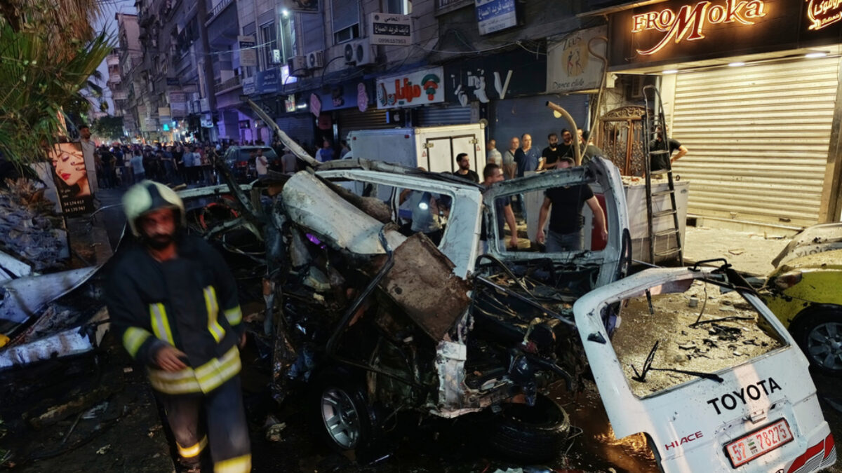 Syrian firefighters and first responders inspect damaged vehicles at the site of an explosion in the Jaramana suburb of Damascus, Syria, Thursday, Aug. 6, 2026. (AP Photo