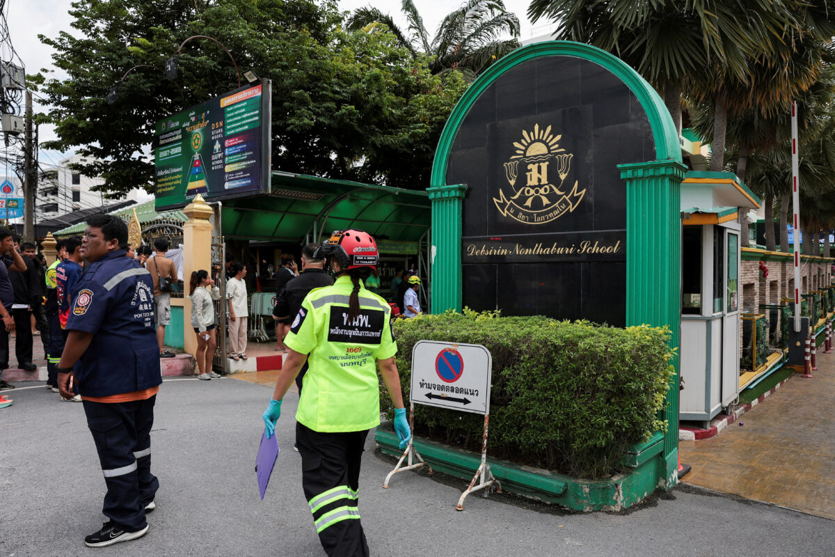 People, including emergency personnel, gather outside Debsirin Nonthaburi School, the site of a shooting incident, in Bang Kruai district in Nonthaburi province on the outskirts of Bangkok, Thailand, August 7, 2026. REUTERS