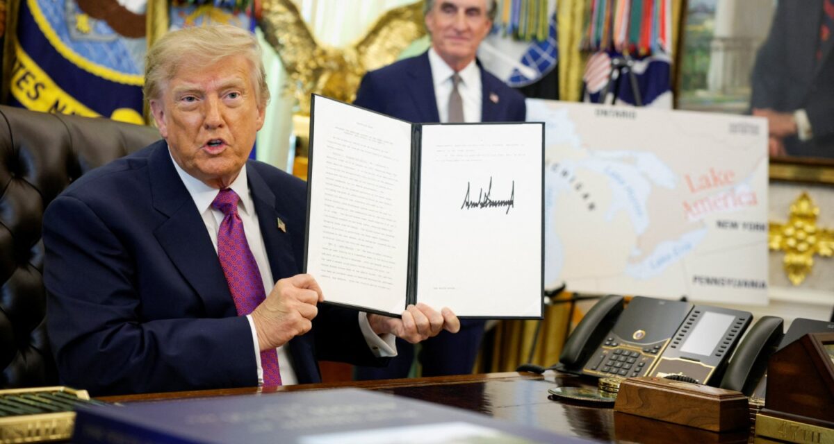 U.S. President Donald Trump holds up an executive order renaming Lake Ontario as Lake America after signing it at the Oval Office of the White House in Washington, D.C., U.S., August 27, 2026. REUTERS/Evan Vucc