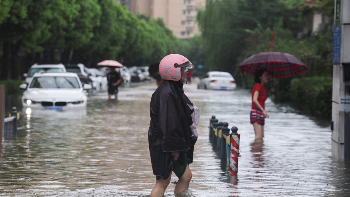 People wade through a flooded street after Typhoon Dolphin brought heavy rain to Shanghai, China, August 10, 2026. REUTERS/Go Nakamura