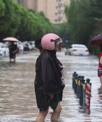 People wade through a flooded street after Typhoon Dolphin brought heavy rain to Shanghai, China, August 10, 2026. REUTERS/Go Nakamura