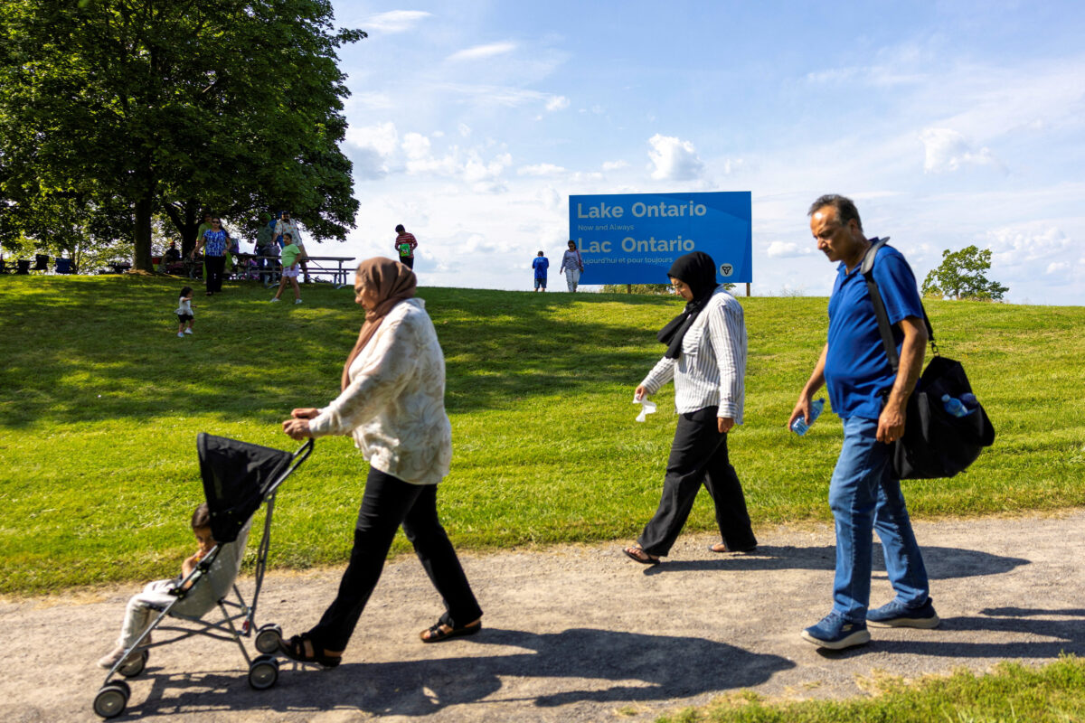 People walk near a sign reading "Lake Ontario, Now and Always," unveiled by Ontario Premier Doug Ford at Fifty Point Conservation Area, after U.S. President Donald Trump signed an executive order renaming Lake Ontario as "Lake America," near Grimsby, Ontario, Canada, August 29, 2026. REUTERS