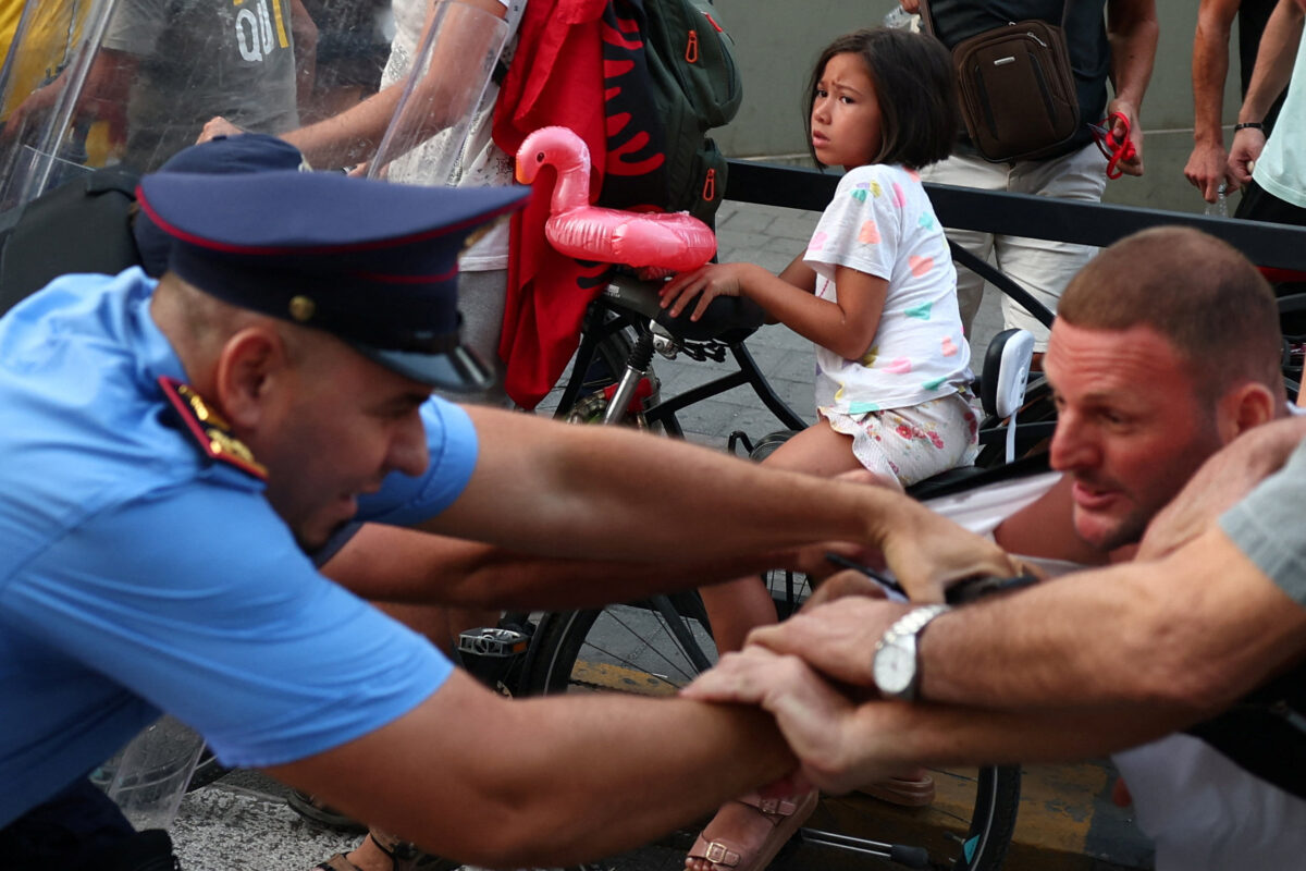 A young girl looks frightened during a demonstration against the government, following months of protests against a planned luxury resort backed by a company linked to Jared Kushner, the son-in-law of U.S. President Donald Trump, on an environmentally sensitive part of the Adriatic coast, in Tirana, Albania, September 8, 2026. REUTERS