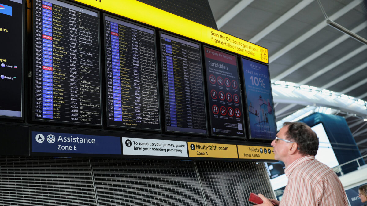 A passenger looks at a departure board displaying cancelled flights at Heathrow Airport's Terminal 5 in London, Britain, September 8, 2026. Some departing flights at major British airports were disrupted on Tuesday after air traffic control provider NATS experienced a technical issue, with Heathrow, Gatwick, Manchester and Stansted among the airports affected by restrictions and delays. REUTERS/Isabel Infantes