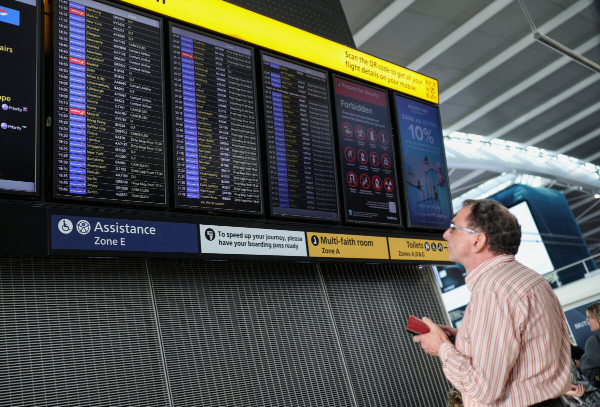 A passenger looks at a departure board displaying cancelled flights at Heathrow Airport's Terminal 5 in London, Britain, September 8, 2026. Some departing flights at major British airports were disrupted on Tuesday after air traffic control provider NATS experienced a technical issue, with Heathrow, Gatwick, Manchester and Stansted among the airports affected by restrictions and delays. REUTERS