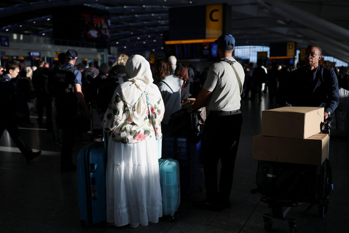 People queue to check in after some departing flights were cancelled at Heathrow Airport's Terminal 5 in London, Britain, September 8, 2026. Some departing flights at major British airports were disrupted on Tuesday after air traffic control provider NATS experienced a technical issue, with Heathrow, Gatwick, Manchester and Stansted among the airports affected by restrictions and delays. REUTERS