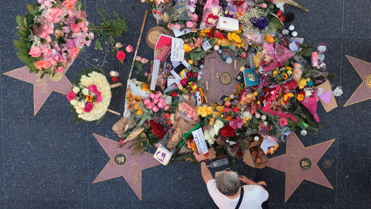 In This aerial view, flowers, notes and photos are left on Dolly Parton's star on the Hollywood Walk of Fame on Wednesday, Aug. 26, 2026, in Los Angeles.