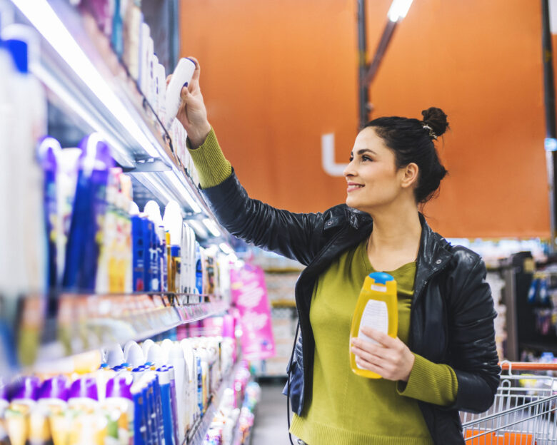 A young woman, housewife, decided to go to the supermarket and buy groceries for his family. the will to cook breakfast, lunch, dinner and everything she wrote on her shopping list. She chooses, fruits, vegetables, wine, cosmetics.