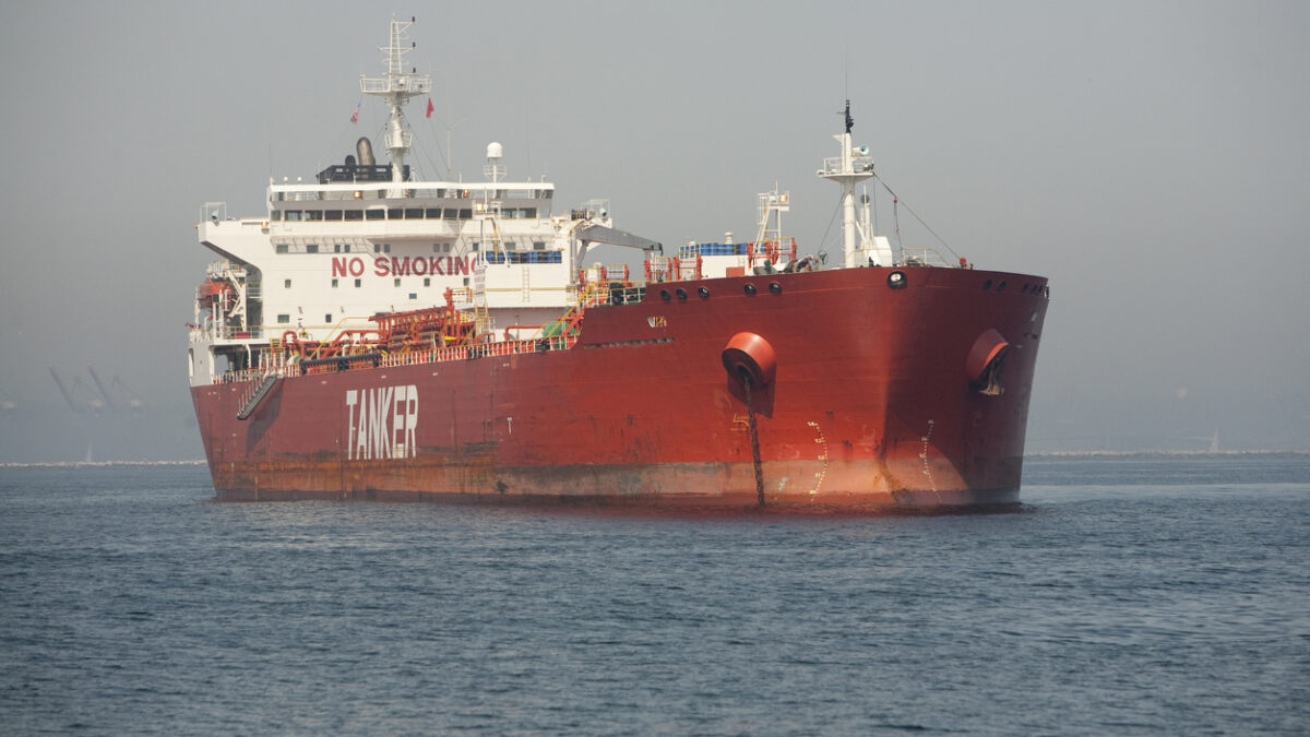 Horizontal image of a red Ultra Large Crude Carrier, or "Super Tanker." These vessels are capable of carrying up to two million barrels of oil across the seas.