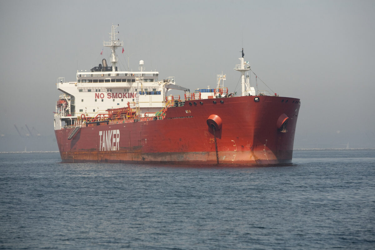 Horizontal image of a red Ultra Large Crude Carrier, or "Super Tanker." These vessels are capable of carrying up to two million barrels of oil across the seas.