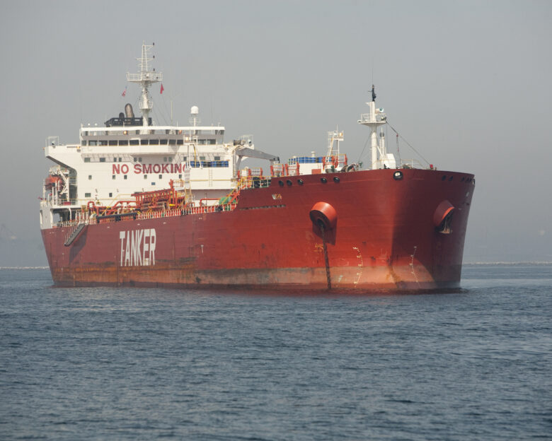 Horizontal image of a red Ultra Large Crude Carrier, or "Super Tanker." These vessels are capable of carrying up to two million barrels of oil across the seas.