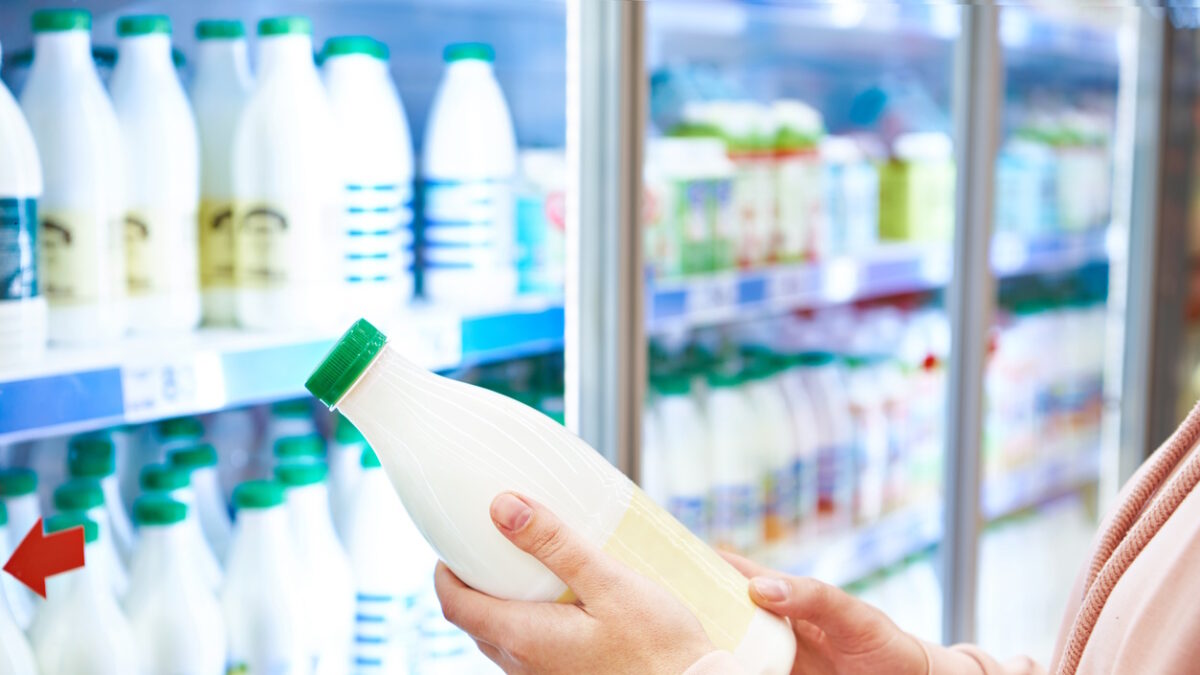 Woman shopping milk in grocery store